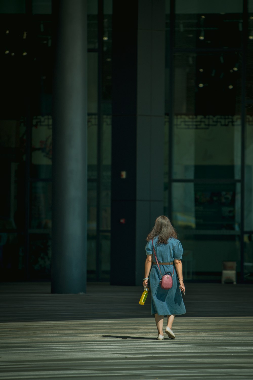 a woman walking on a sidewalk