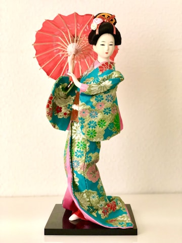 a statue of a person holding an umbrella