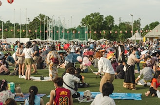 a group of people dancing in a field with a crowd watching
