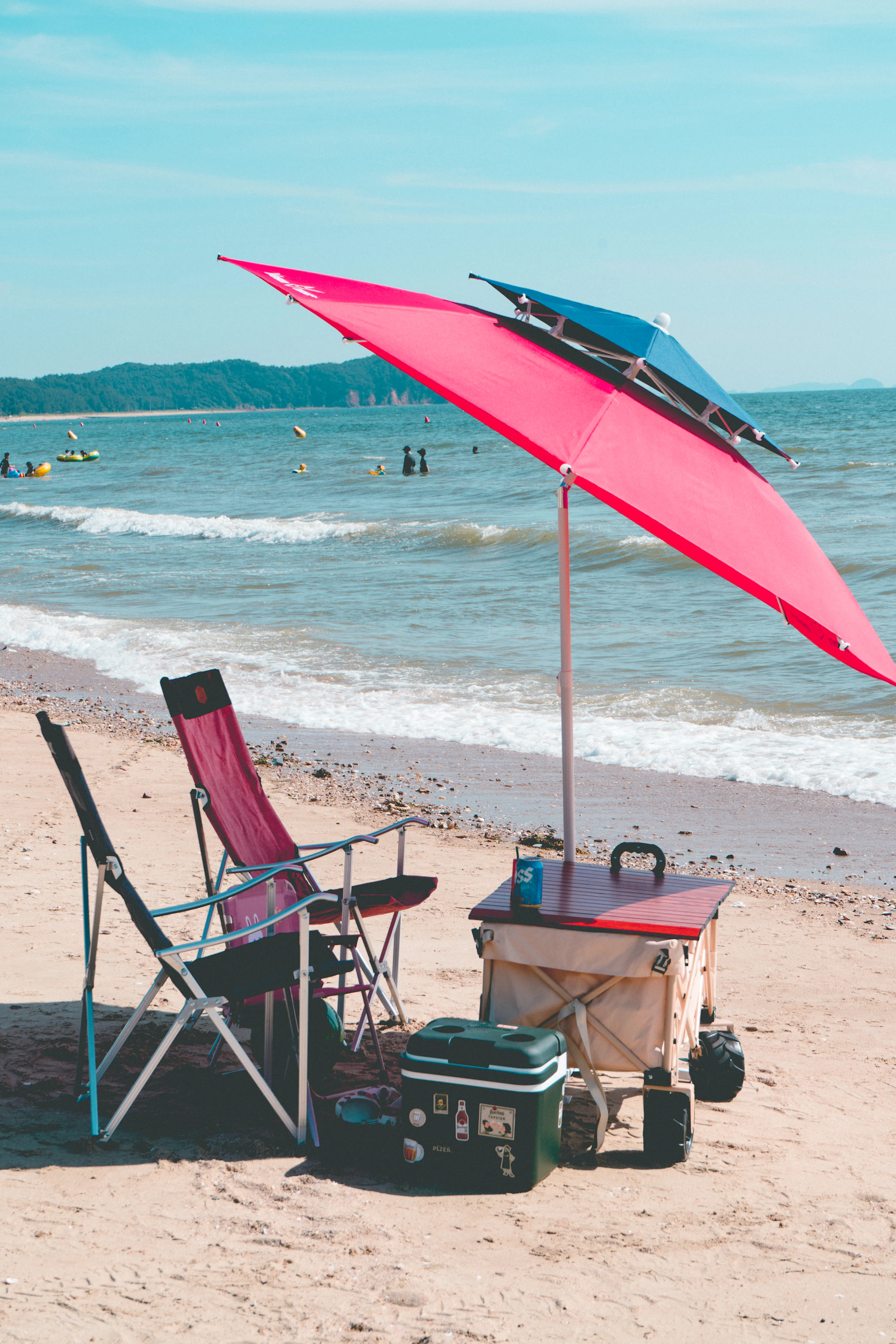 a beach with chairs and umbrella