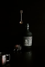 a bottle of alcohol and a cup