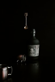 a bottle of alcohol and a cup