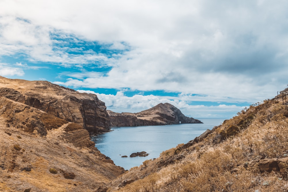 a body of water surrounded by hills