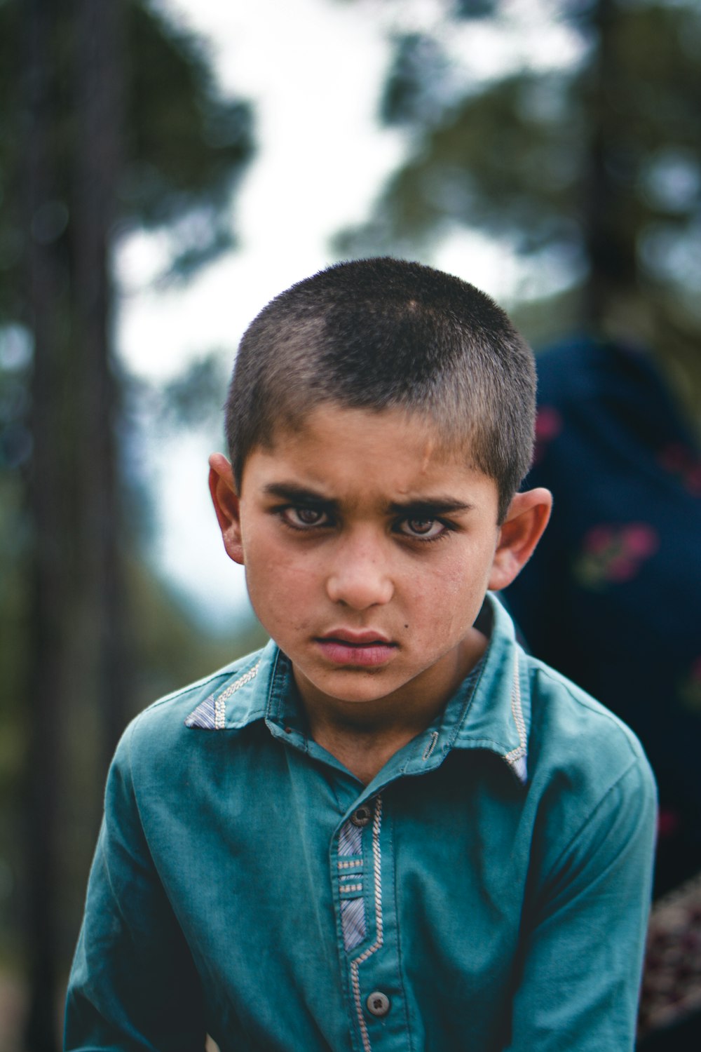 a young boy in a blue shirt