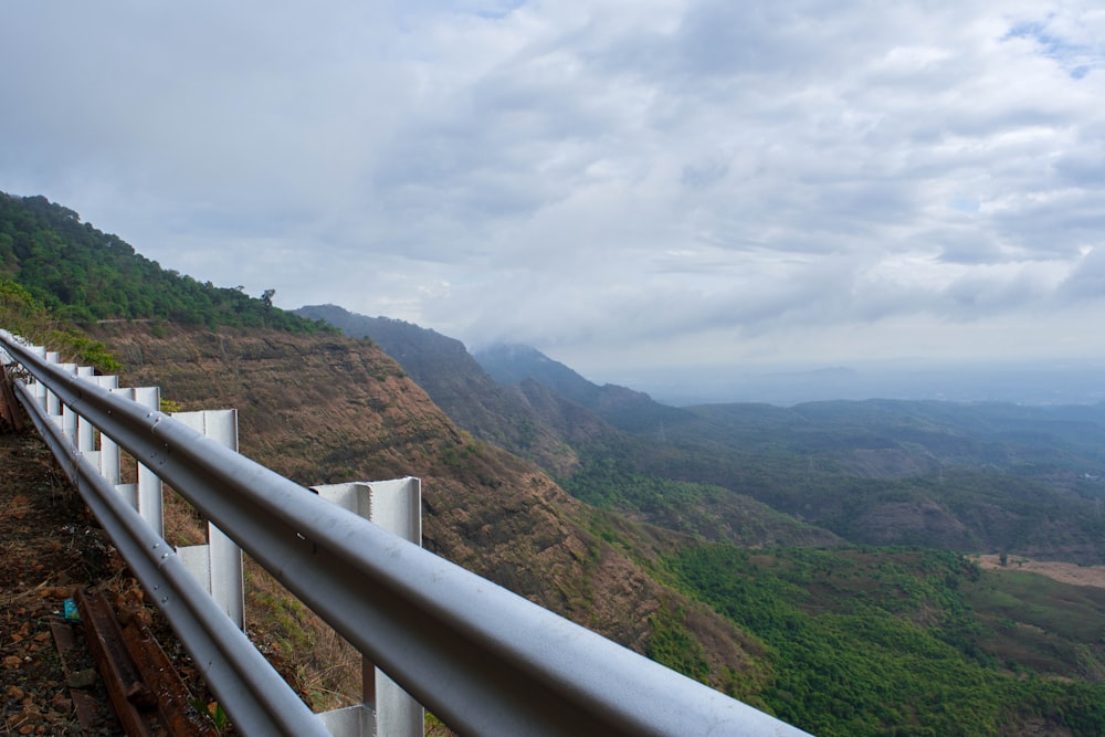 a wooden fence overlooking a valley