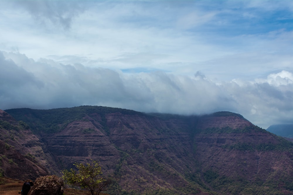 a landscape with hills and clouds