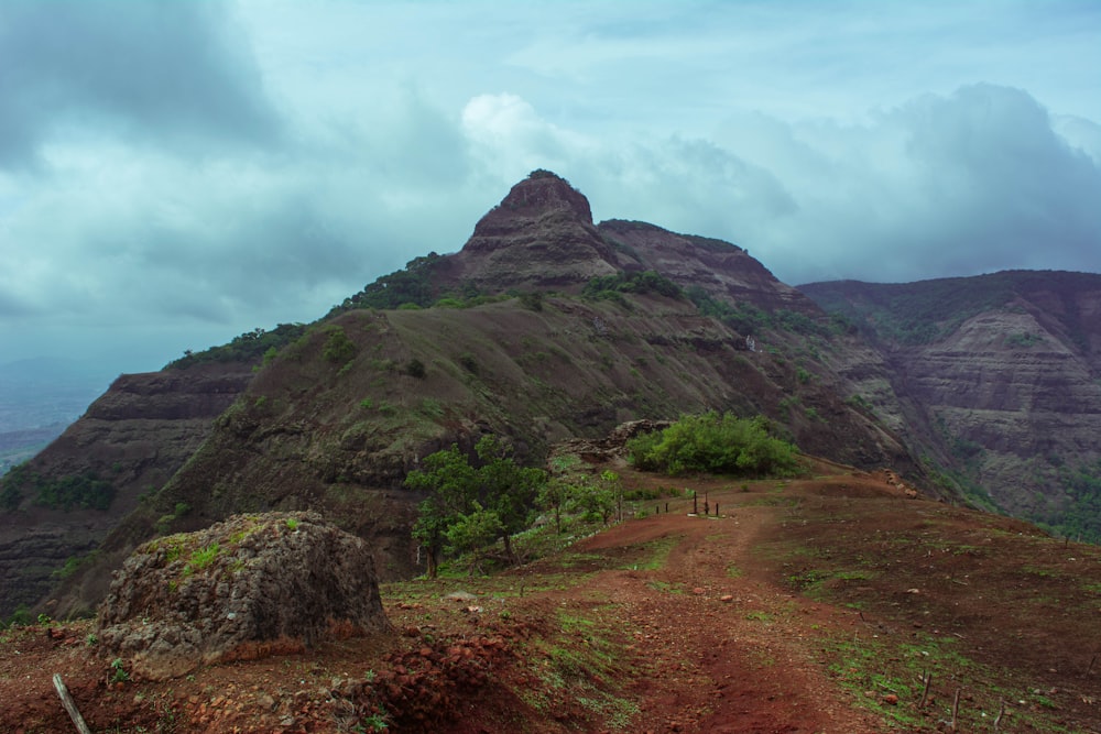 a dirt road leading up to a mountain