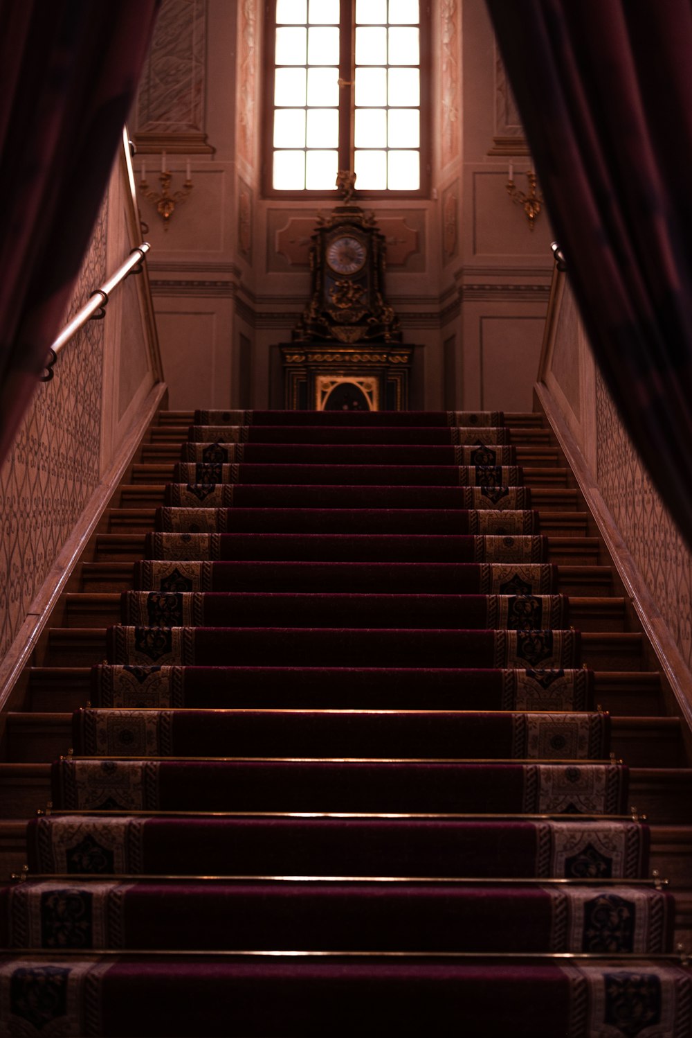 a staircase with a statue on the top