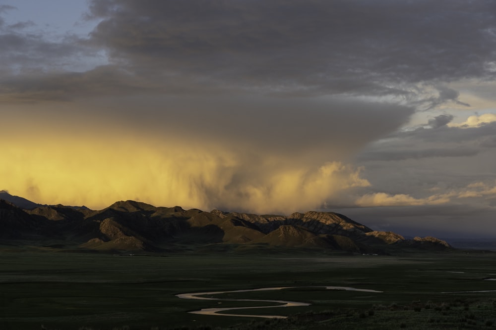 a landscape with mountains in the back