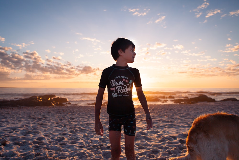 a boy standing on a beach