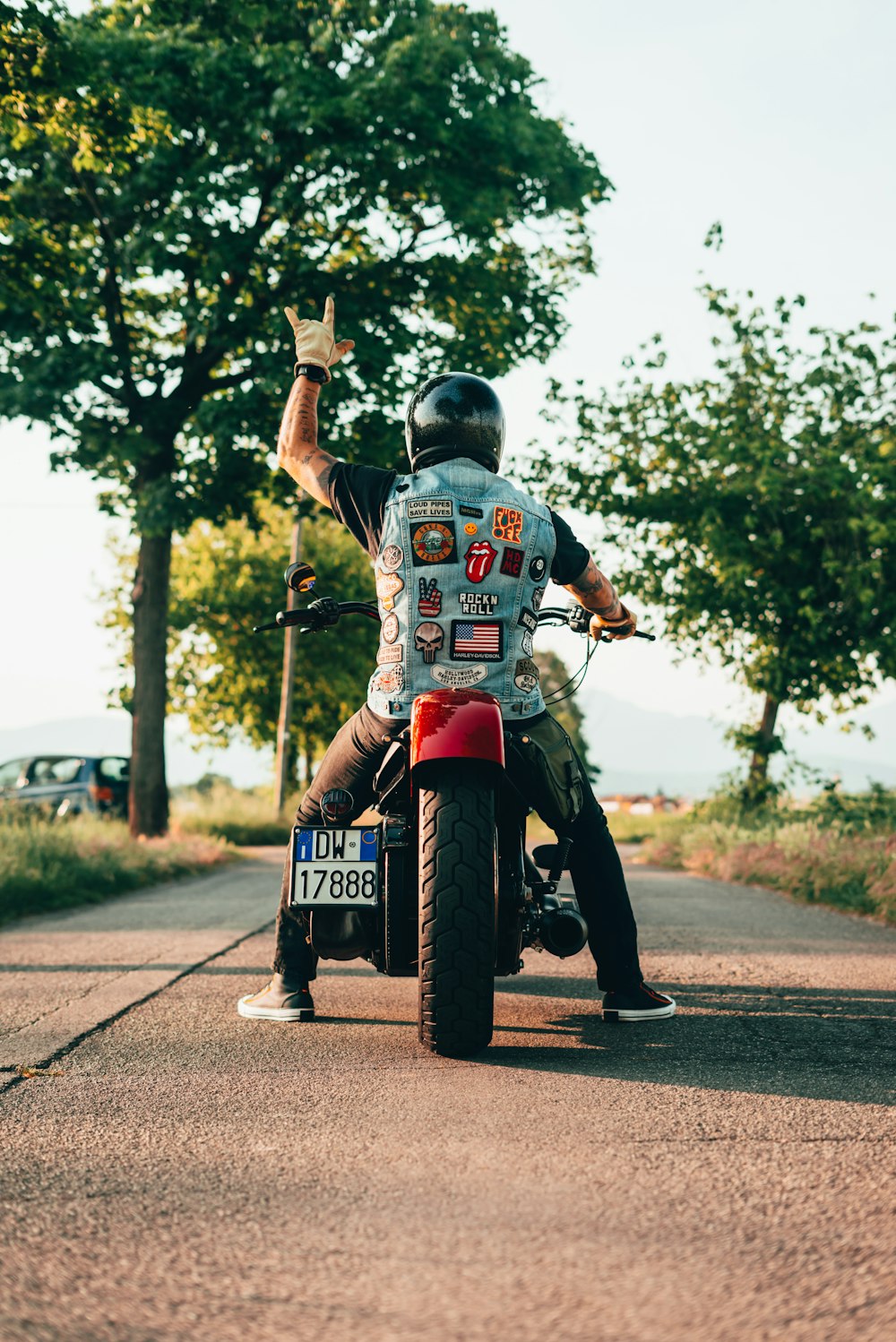 a man on a motorcycle waving