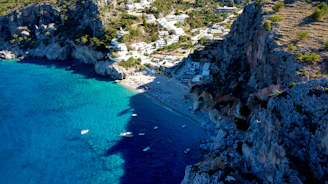 a rocky beach with boats