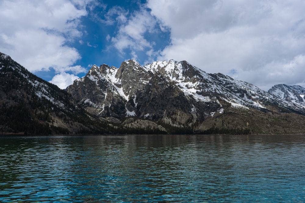 a body of water with mountains in the background