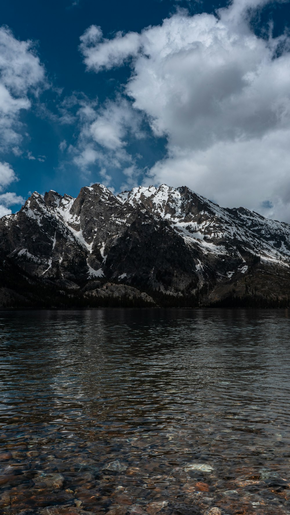 a body of water with a mountain in the background