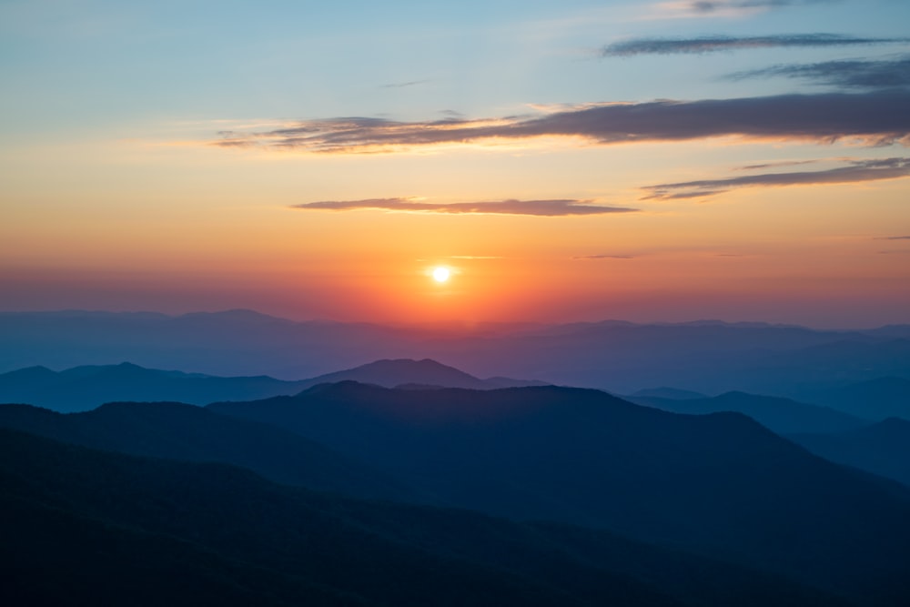 a sunset over a mountain range