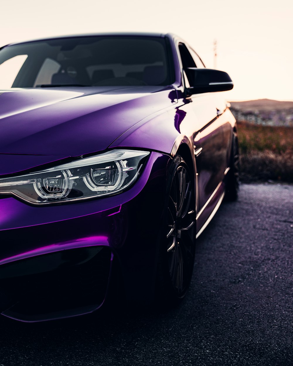 a purple car parked on a road