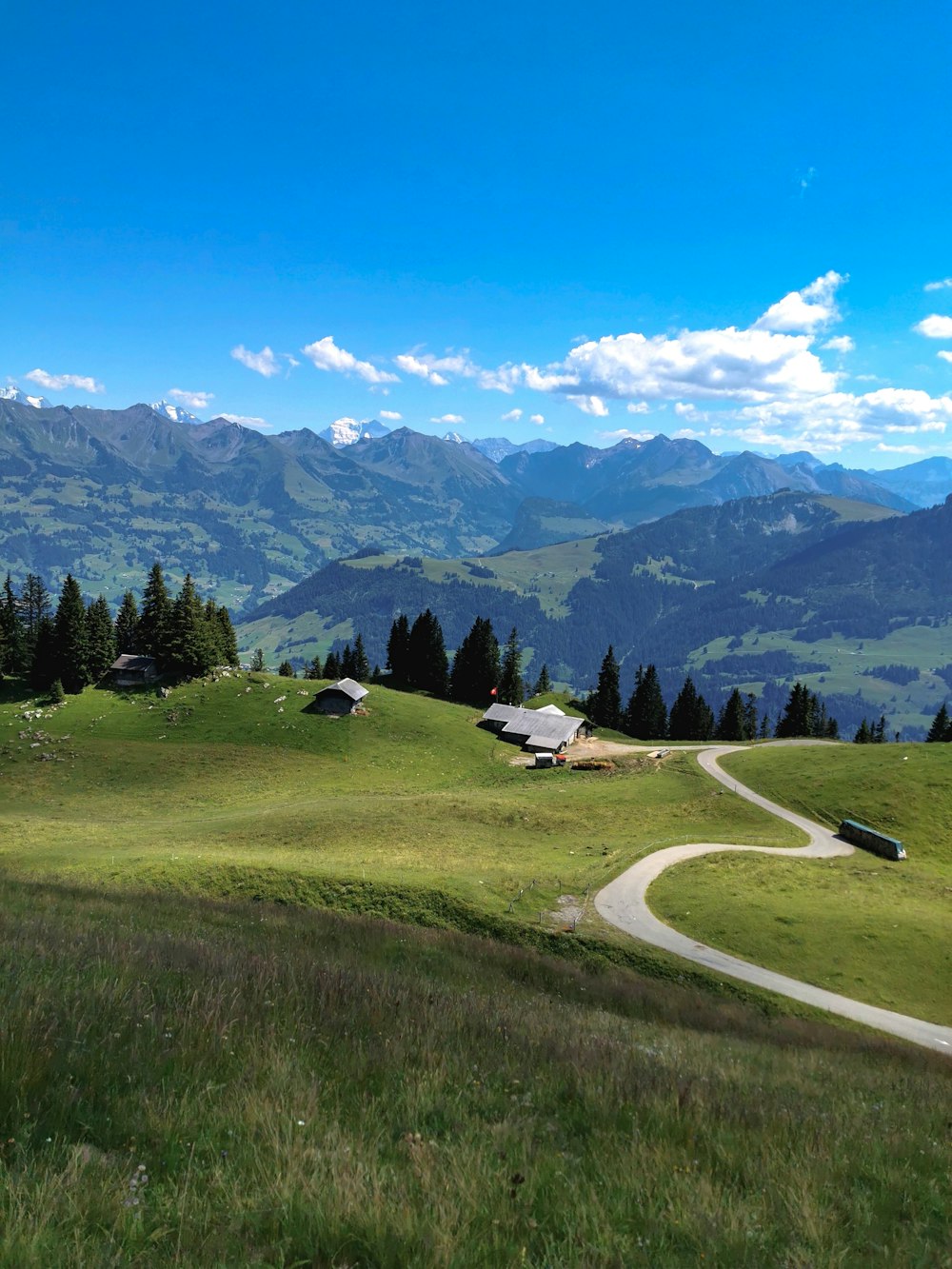 a road leading to a house and mountains