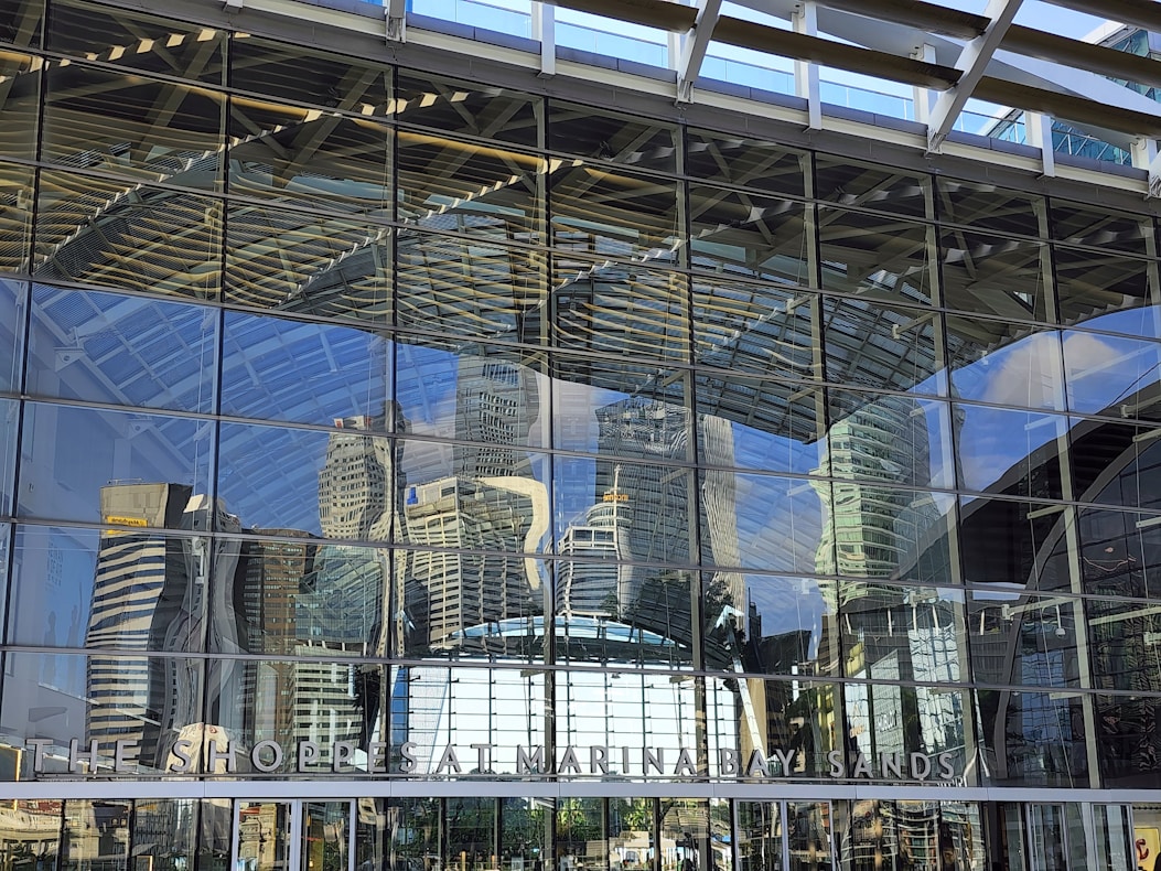 Reflection of a city skyline on a spotless commercial glass facade being polished
