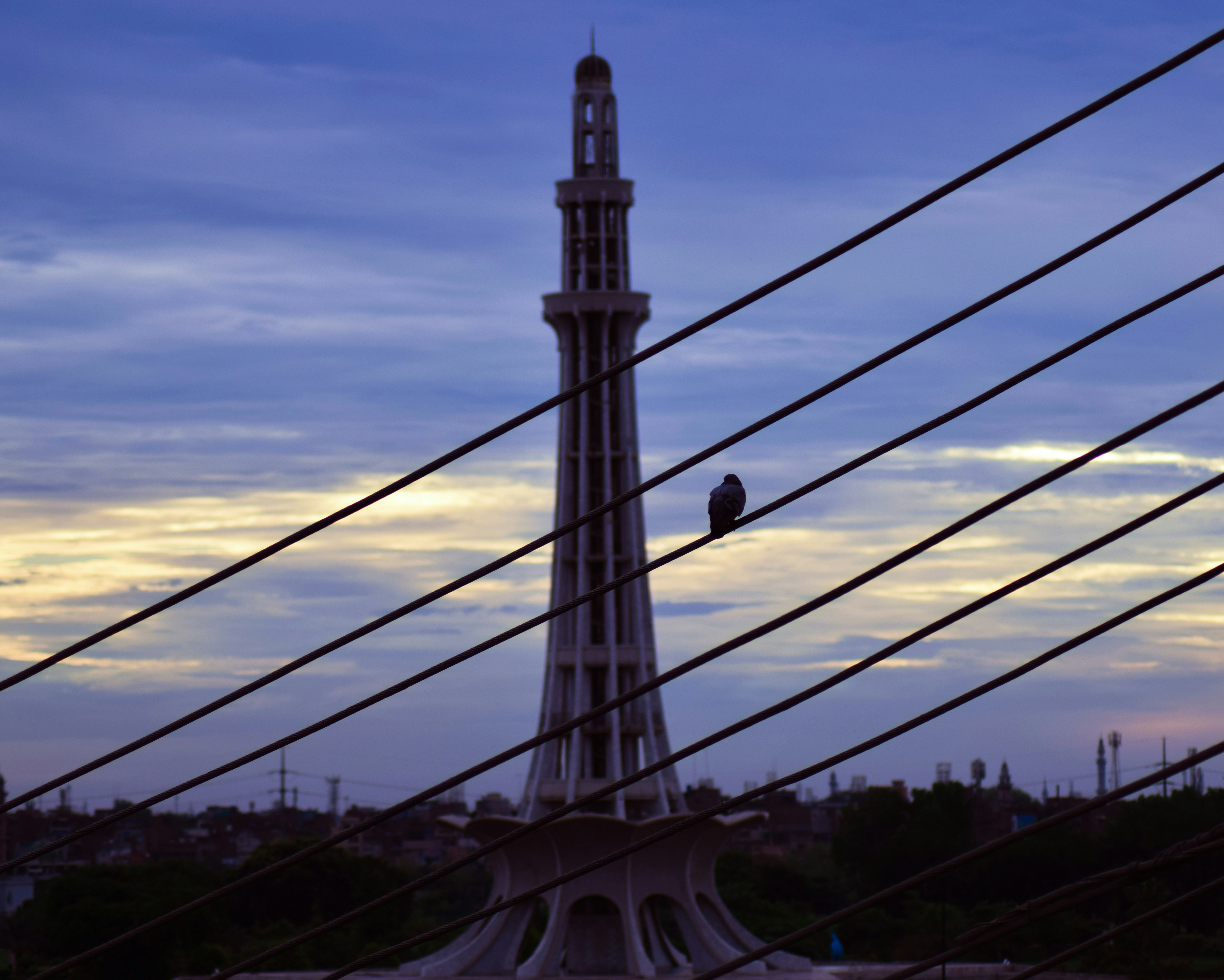 a tall tower with cables