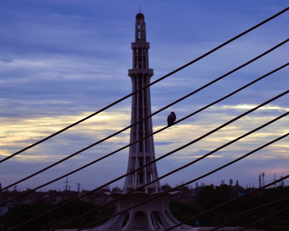 a tall tower with cables