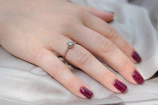a woman's hand with a ring on her finger