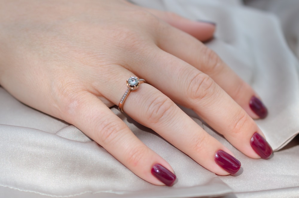 a woman's hand with a ring on her finger