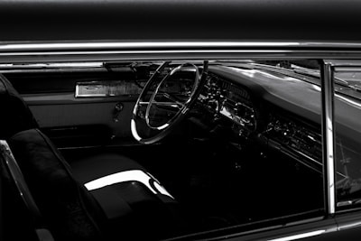 Vintage car interior showcasing restored headliner and plush carpet, reflecting timeless elegance.