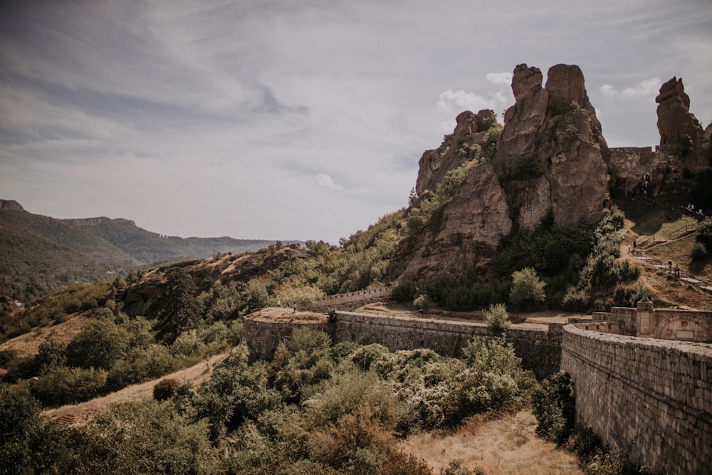 a stone wall and a mountain