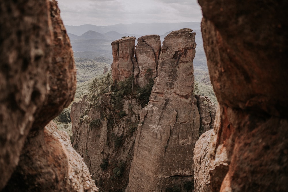 a rocky cliff with a valley below