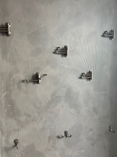 Wall-mounted hooks and hanging organizers for action figures and craft supplies.