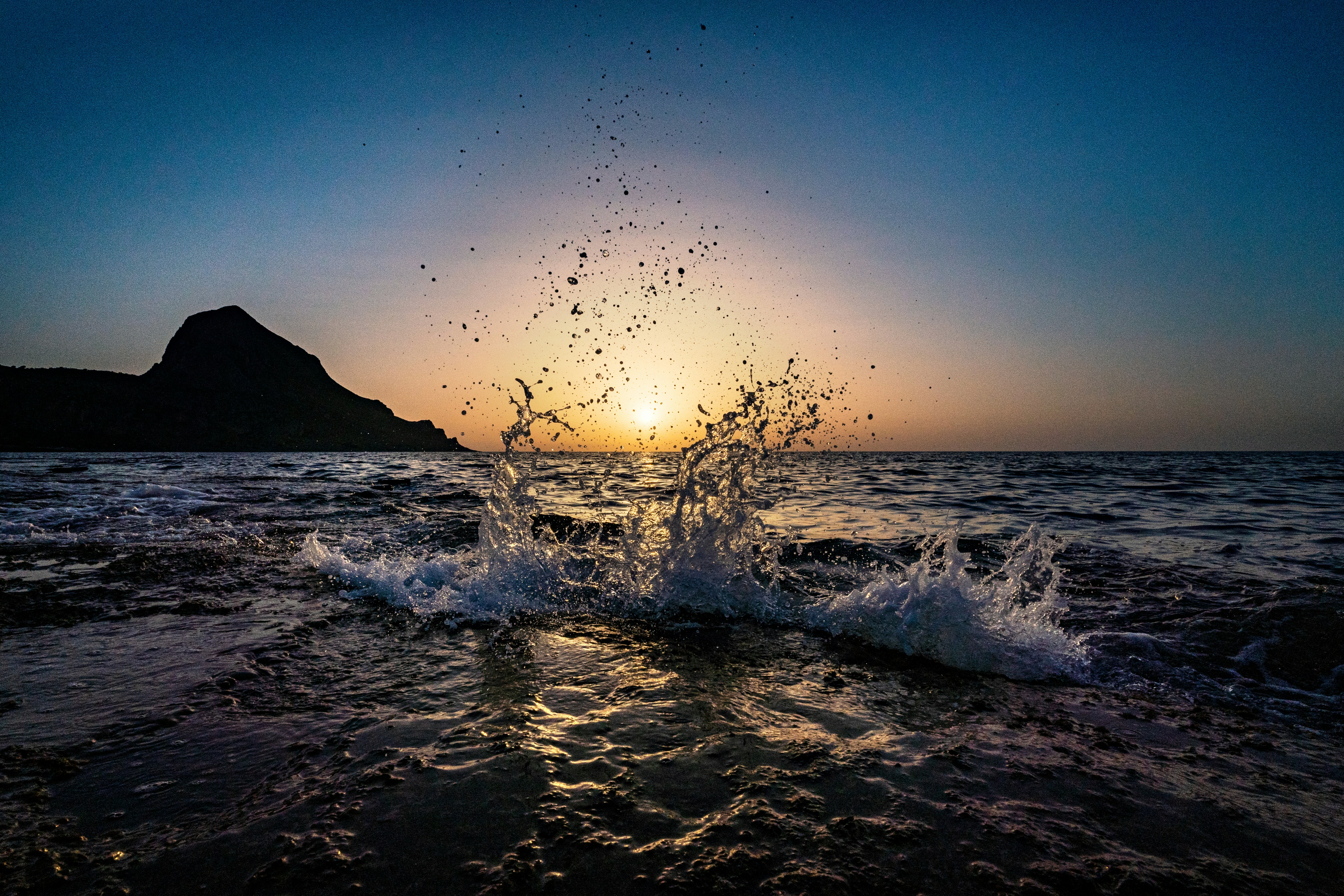 a wave crashing on a beach