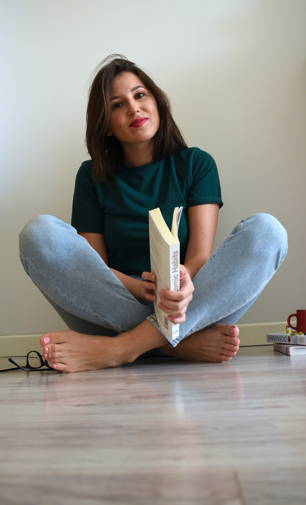 a person sitting on the floor holding a piece of paper