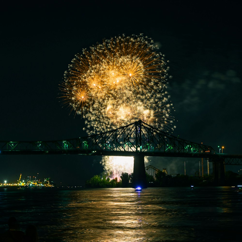 fireworks over a bridge at night