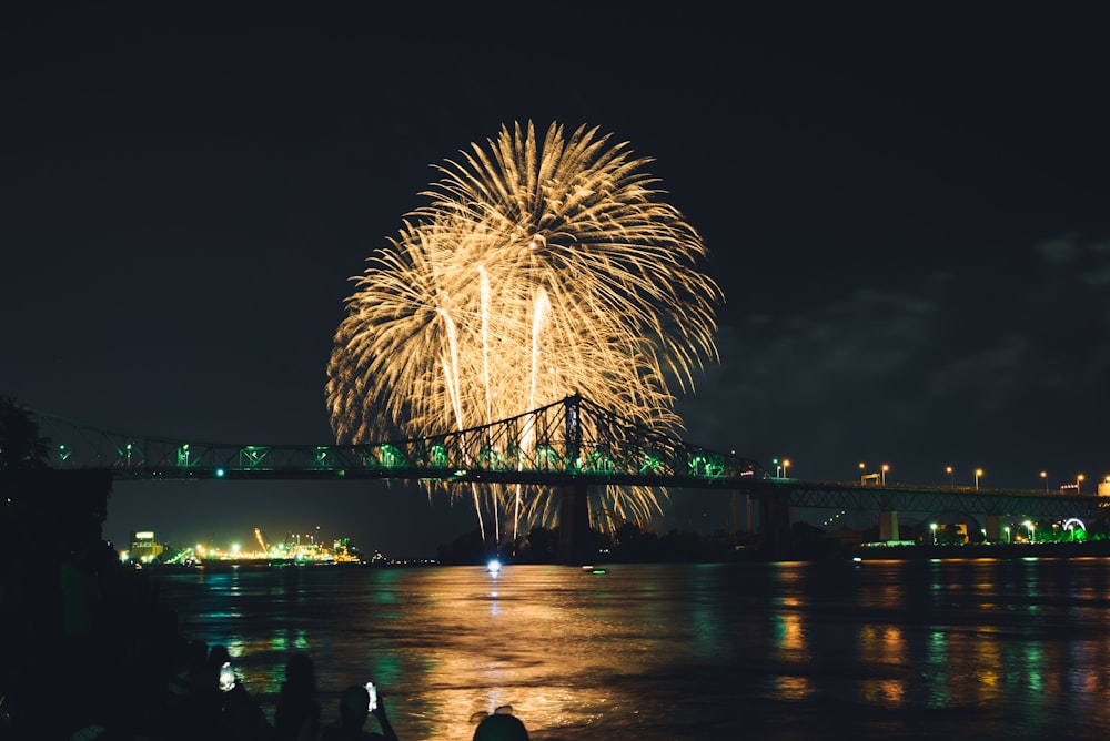 fireworks going off over a bridge
