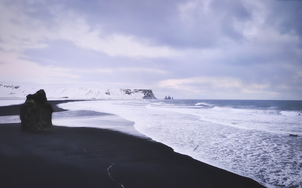 a beach with waves crashing on it