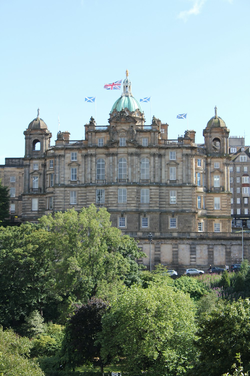 a large building with flags on top