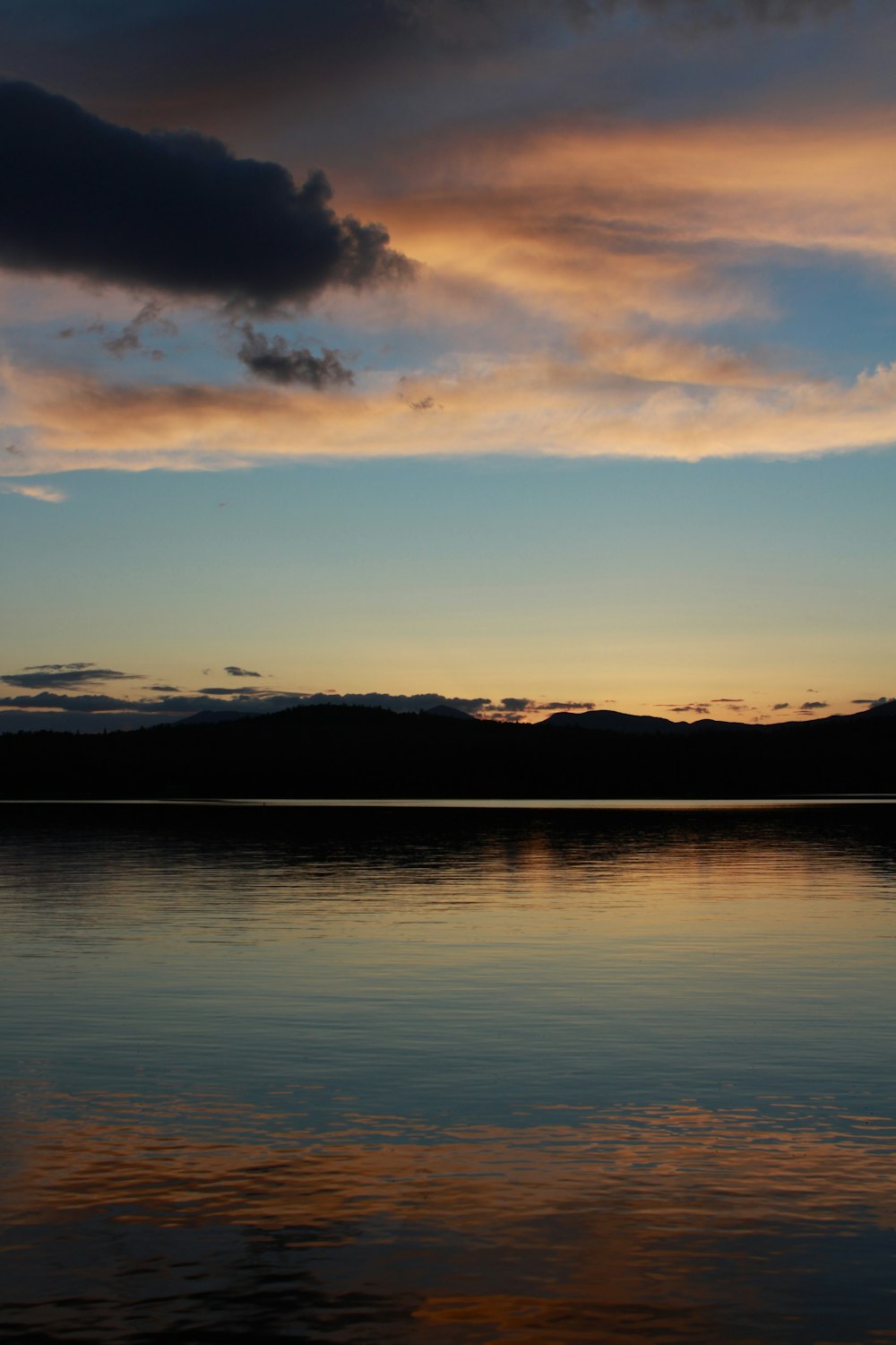 a body of water with mountains in the background