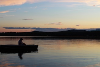 a person in a boat on a lake