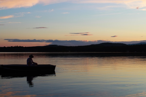 a person in a boat on a lake