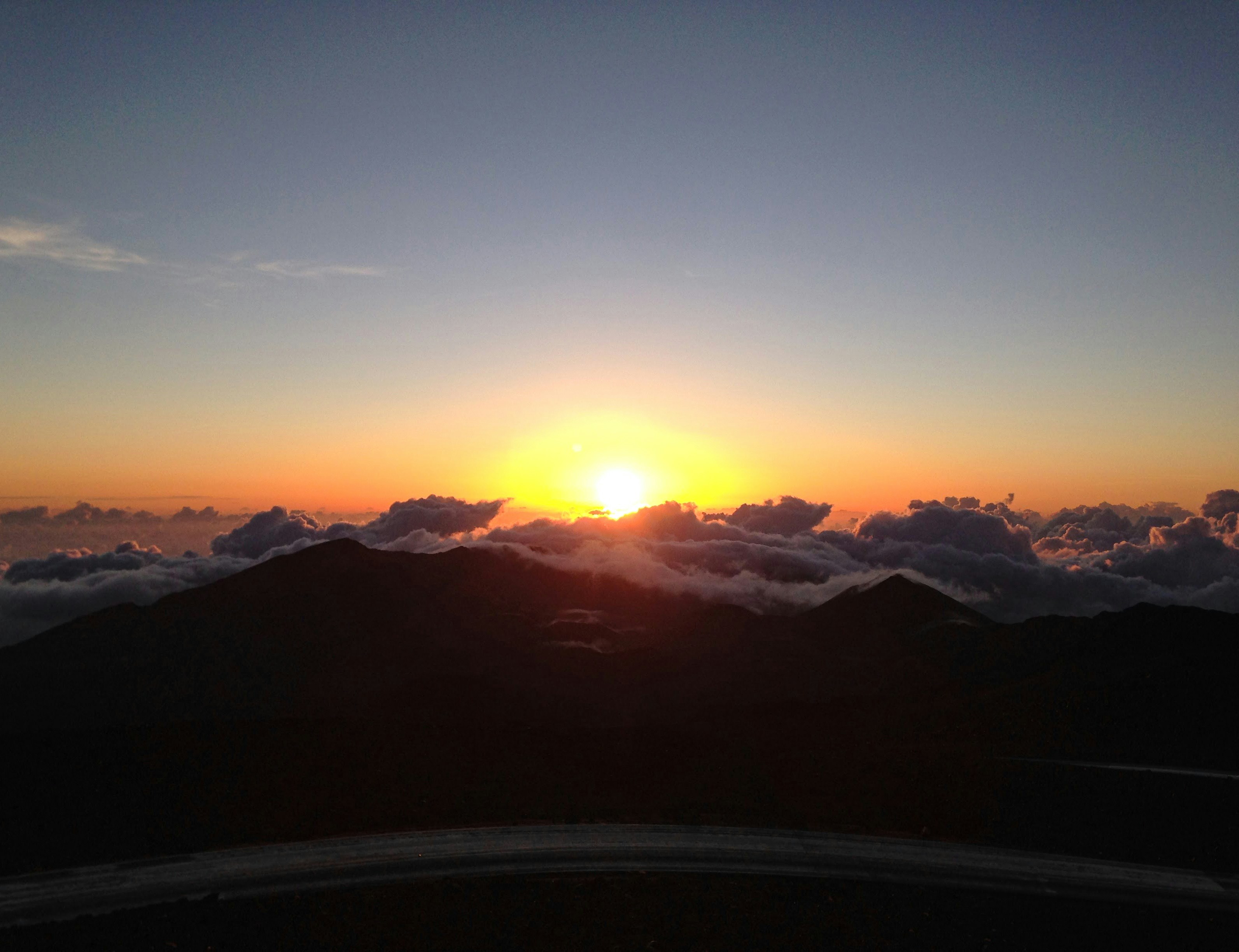 a sunset over a mountain range