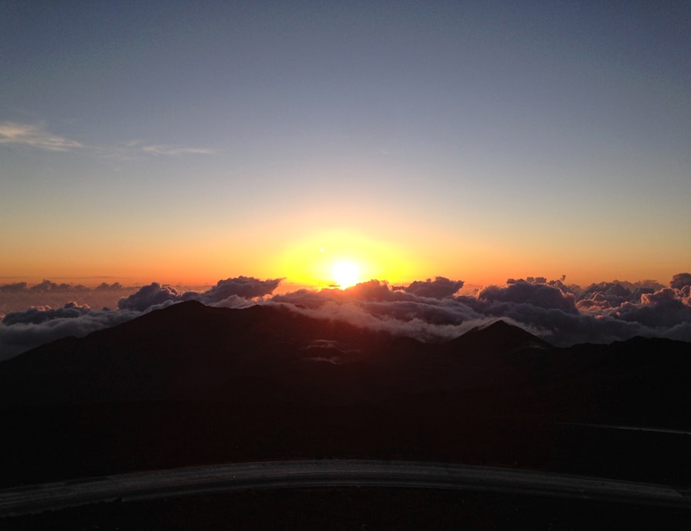 a sunset over a mountain range