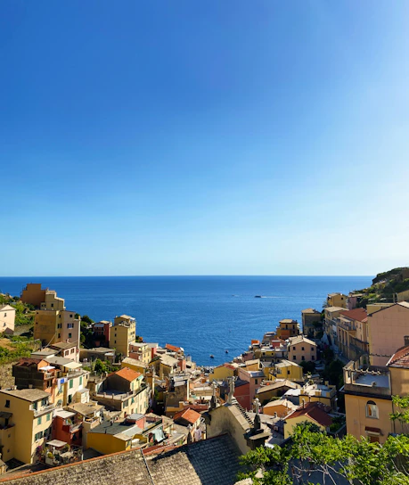 A sunlit coastal view of the French Riviera with turquoise waters and charming Mediterranean architecture.