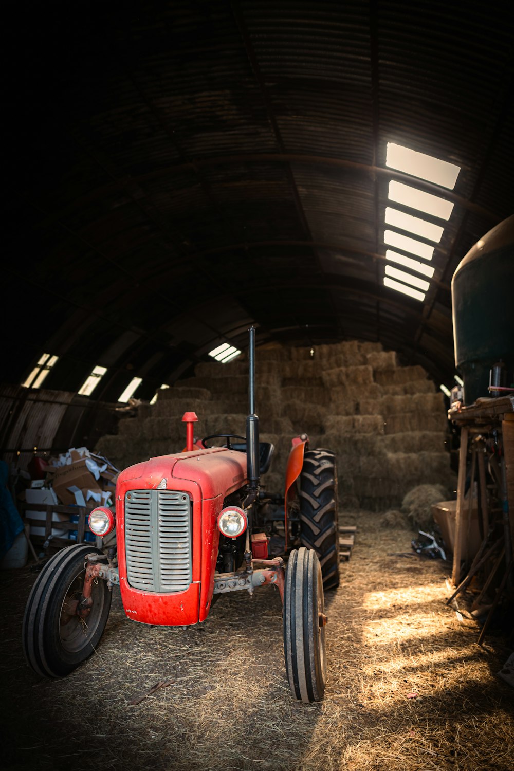 a red tractor in a barn