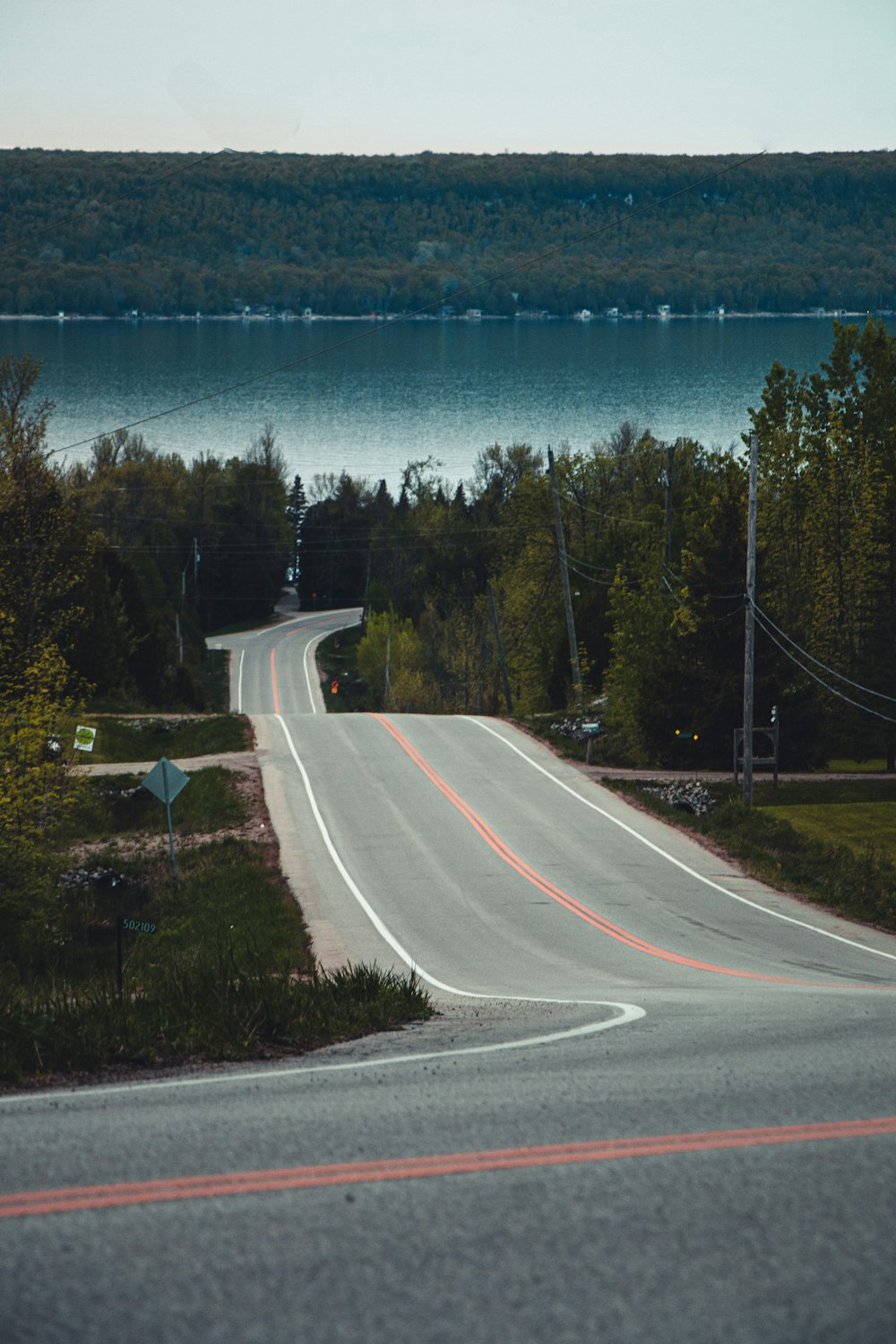 a road next to a body of water