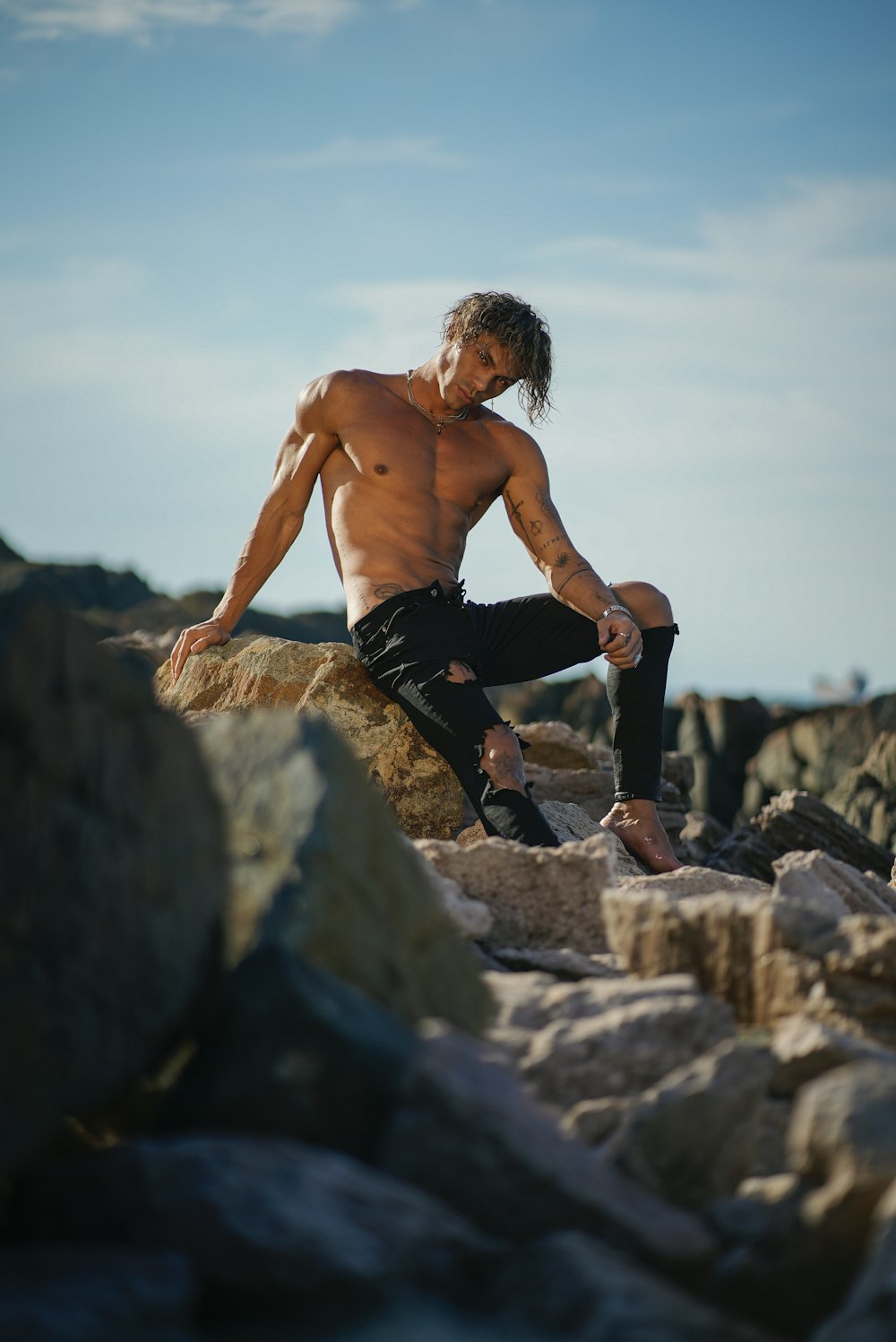 a man jumping off a rocky cliff