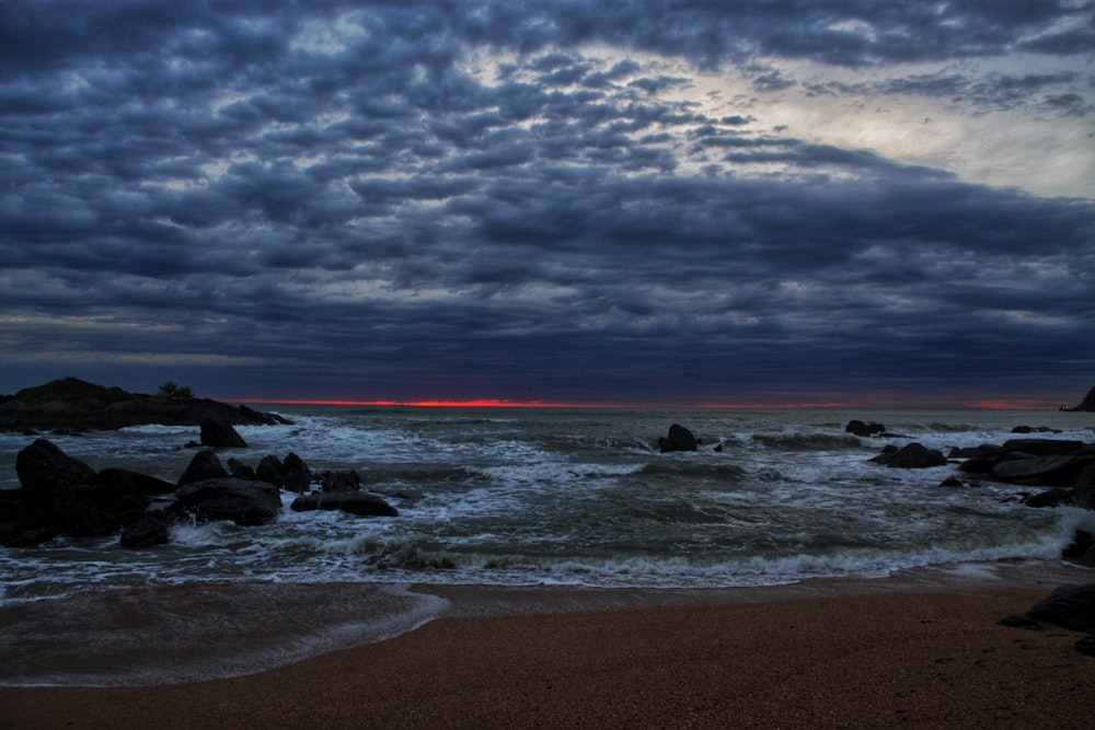 a beach with rocks and water