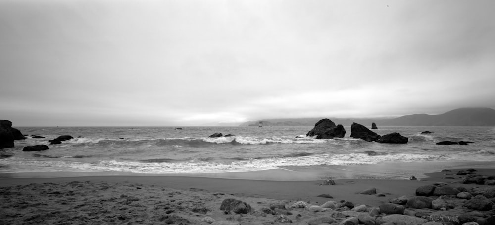 a rocky beach with waves crashing