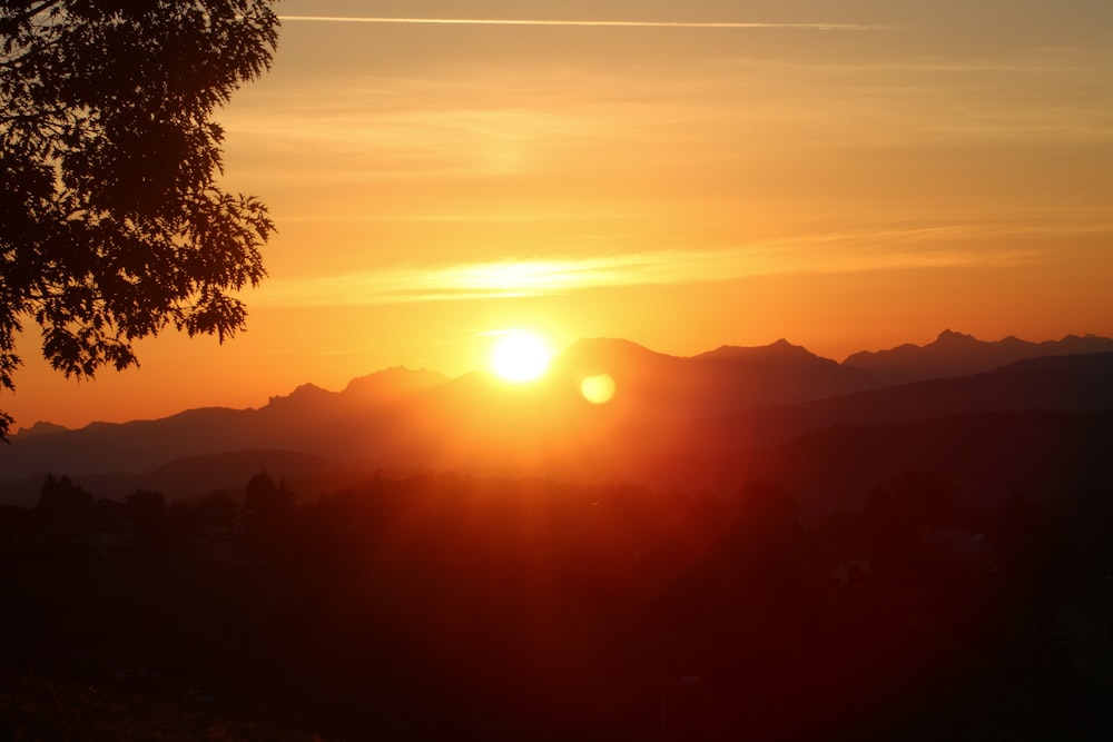 a sunset over a mountain range