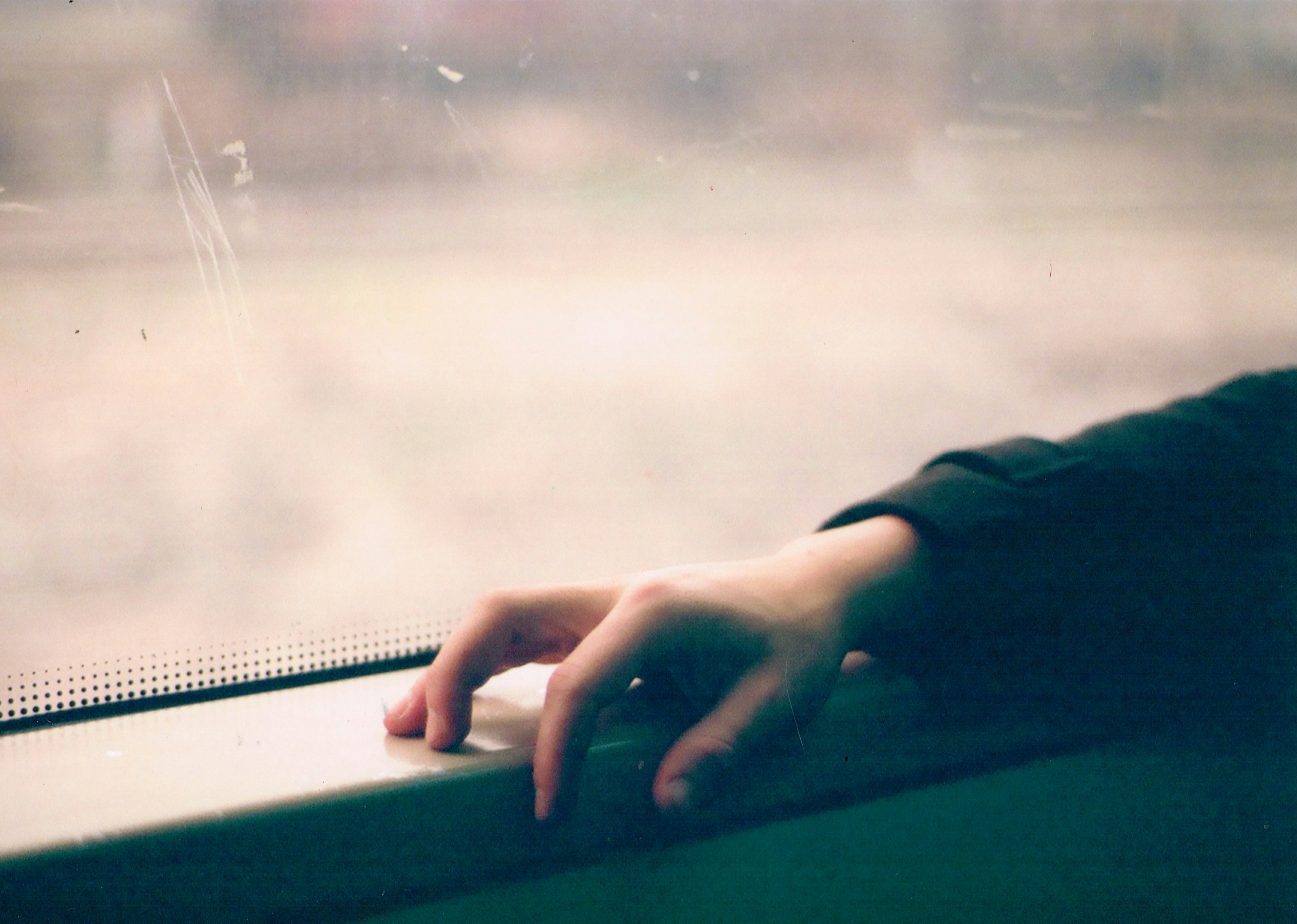 a person's hand on a window seal