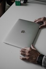 a person's hands on a laptop